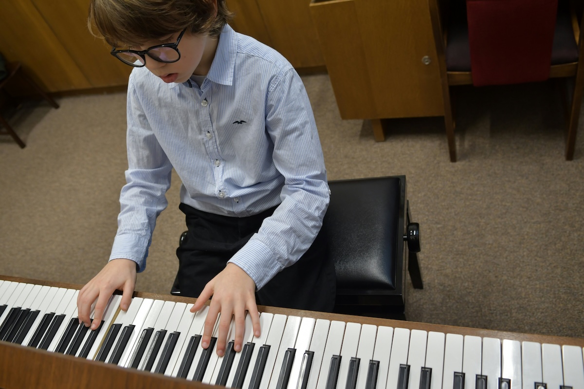 Young boy playing a piano